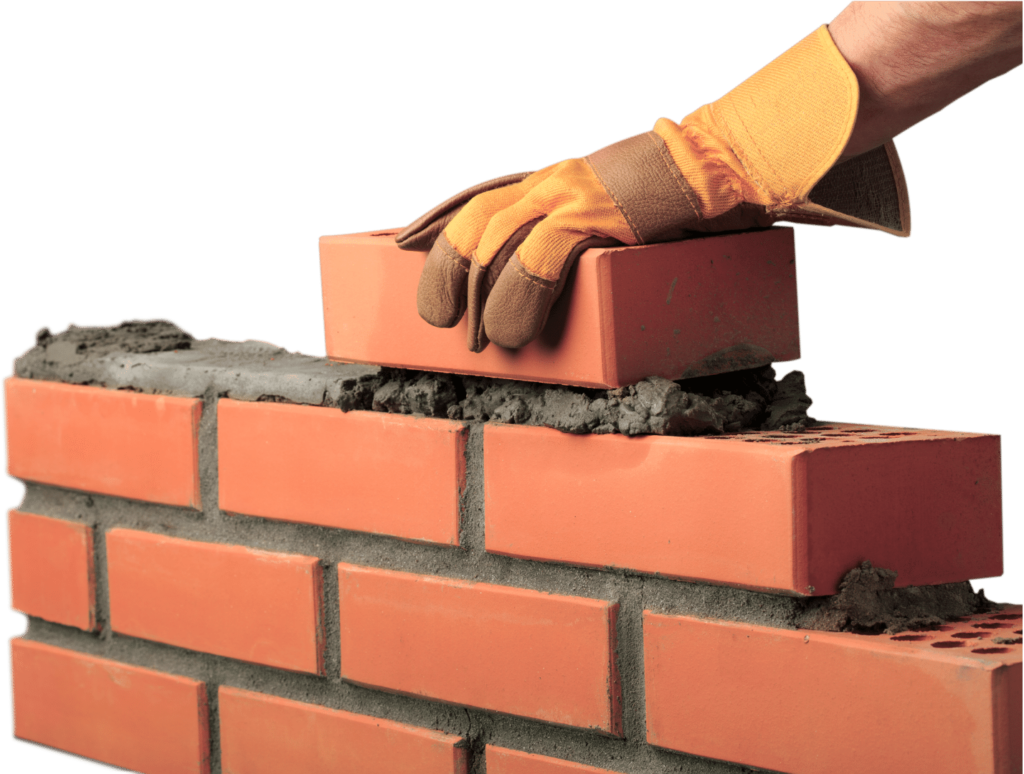 placing a brick in place for a retaining wall - Brick Fences & Retaining Walls