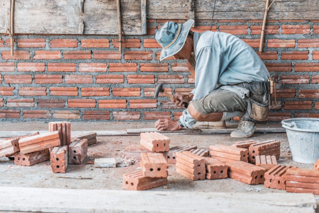 brick fireplaces - mason repairing a brick wall